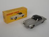a close up of a toy car next to a box of dinky toys