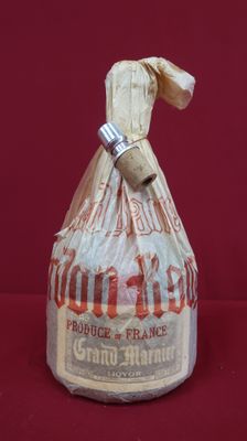 a bag of bread wrapped in plastic on a red surface