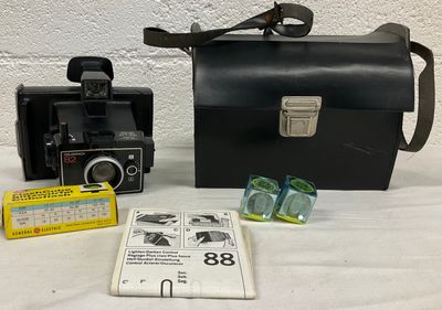 a black bag and a black camera on a table