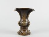 an image of a bronze vase sitting on top of a white surface