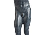 statue of a man with a raised arm on a wooden base