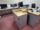 two desks with computers on them in a room