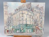 an oil painting of a building on a wooden easel on a table