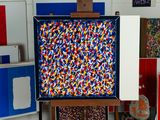 a picture of an easel with a painting on it in a room
