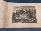 an old book with a picture of a castle on top of it
