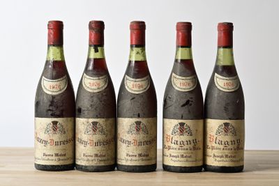 four bottles of wine are lined up on a table
