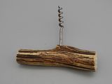 a close up of a piece of wood with a corkscrew on it