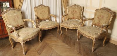 four chairs and a cabinet in a room