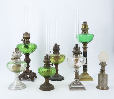 many different types of glass lamps on the table