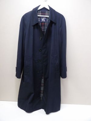 the coat is hanging on a hanger on the wall