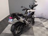 a motorcycle that is parked on a checkered floor