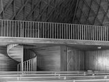 black and white photograph of a staircase in a building with a spiral staircase