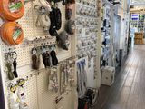many different types of hoses hanging on the wall