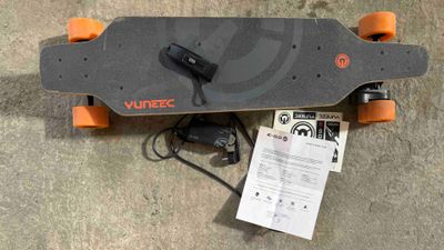a skateboard that is laying on the ground next to a charger