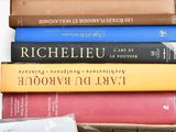 many books stacked on top of each other on a table