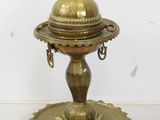 an antique brass plate with a dome on top of it