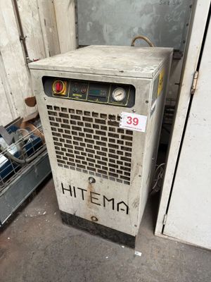 a small air conditioner that is sitting in the corner of a room
