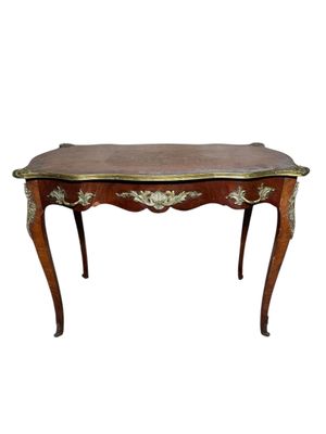 a small table with a wooden top and gold trimmings