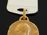 a close up of a gold medal with a tag on it
