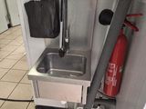 a kitchen with a sink and a fire extinguisher