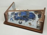 a model of a car in a glass case on a table
