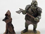 two figurines of a man and a woman standing next to each other