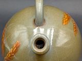 an image of a vase with a handle on a table