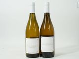 two bottles of wine sitting next to each other on a table