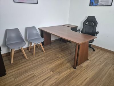 an image of a conference room with chairs and a desk