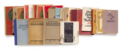 several books are stacked on top of each other on a white surface