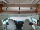 a view of the inside of a camper van from the driver ' s seat