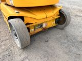 a yellow construction vehicle that is parked in the dirt