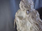 a white sculpture of a woman holding a child