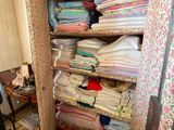 a closet full of clothes and a chair in a room