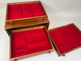 three wooden boxes with red velvet linings on them