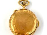 an image of a gold pocket watch on a white surface