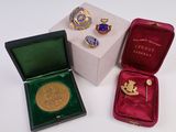 three different types of brooches in a box on a white surface