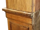 a wooden cabinet with a clock on top of it