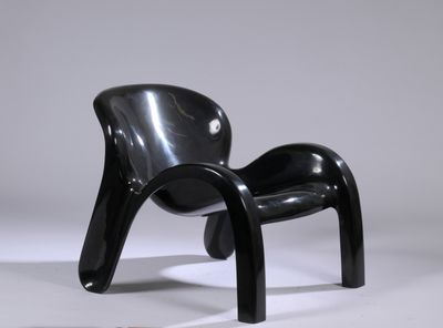 a black chair that is sitting on a white surface