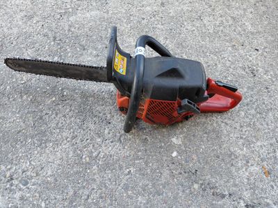 an image of a chainsaw sitting on the ground