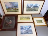four framed pictures of mountains and a man sitting on a bench
