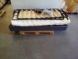 a bed that is made out of pallets in a warehouse