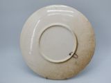 a white plate that has a small hole in it