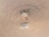 a close up of a silver vase with a number 3 on it