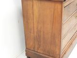 a wooden dresser with a marble top in a room