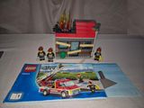 a lego fire station with a fire truck and a fireman