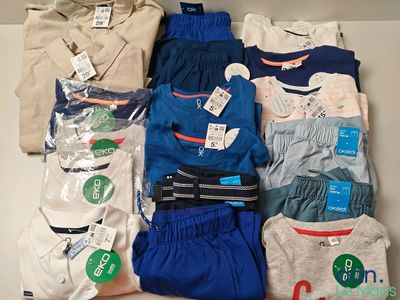 a lot of men ' s clothing that are on the table