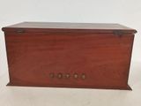 an old wooden box with four buttons on the front