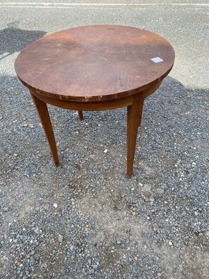 an image of a small round table on a gravel ground
