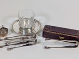 a glass of water and silverware sitting on a table